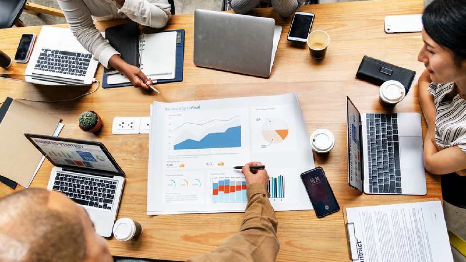 Business report gathering around table to review