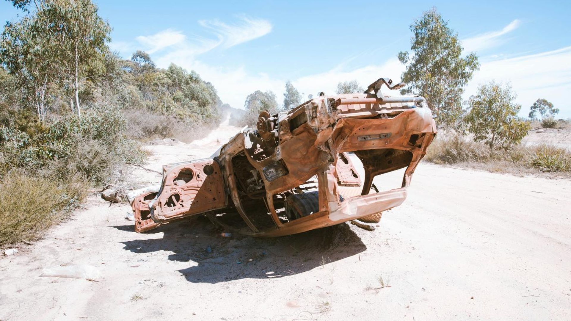 upside down car, destroyed on sand