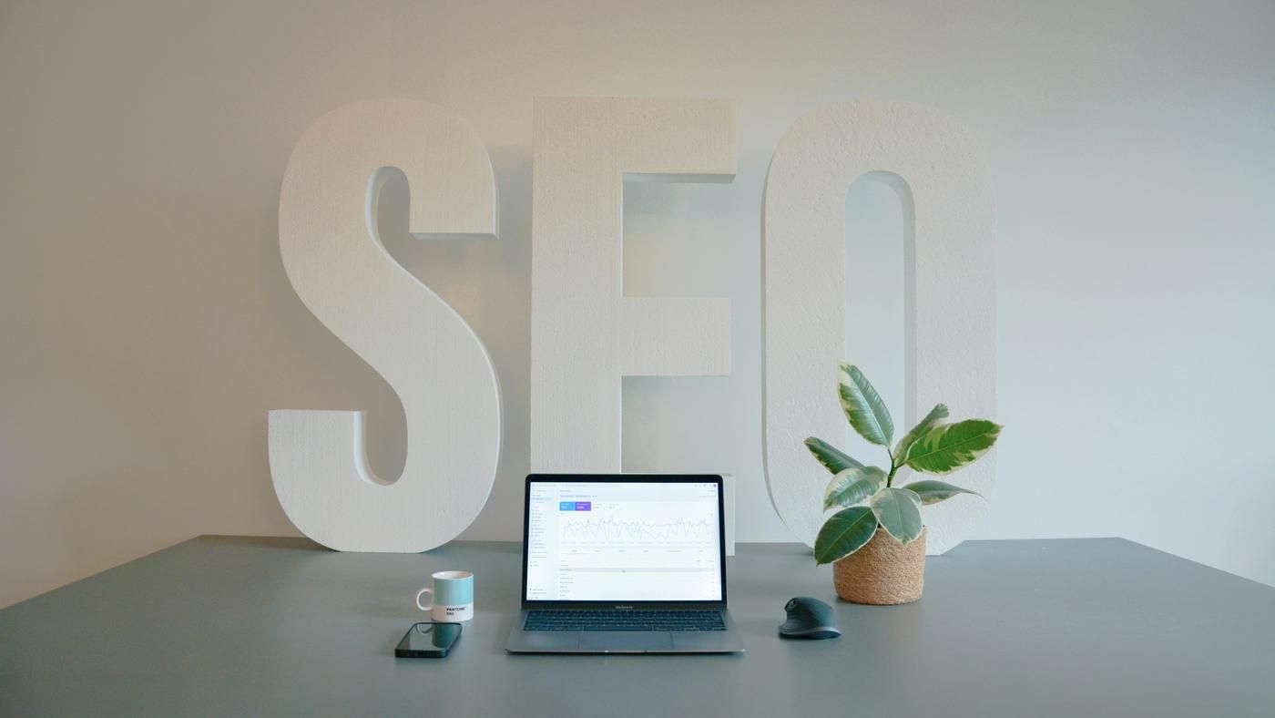 seo agency sign, marketing firm table with laptop and plant