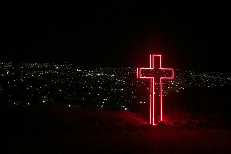 a cross in the city at night