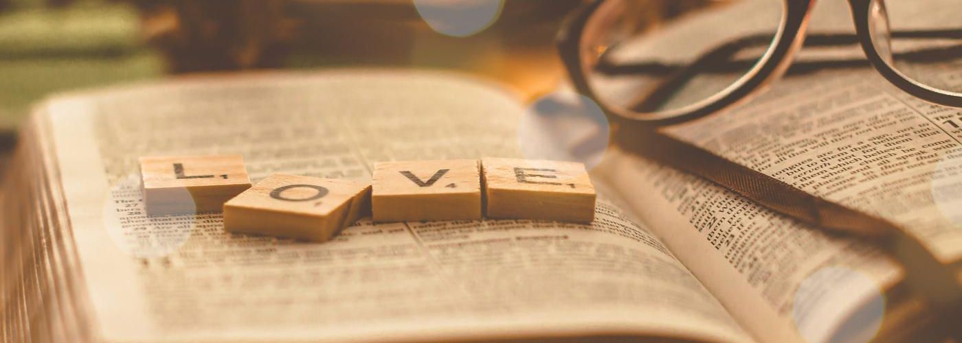 love letters on the bible on a desk with glasses