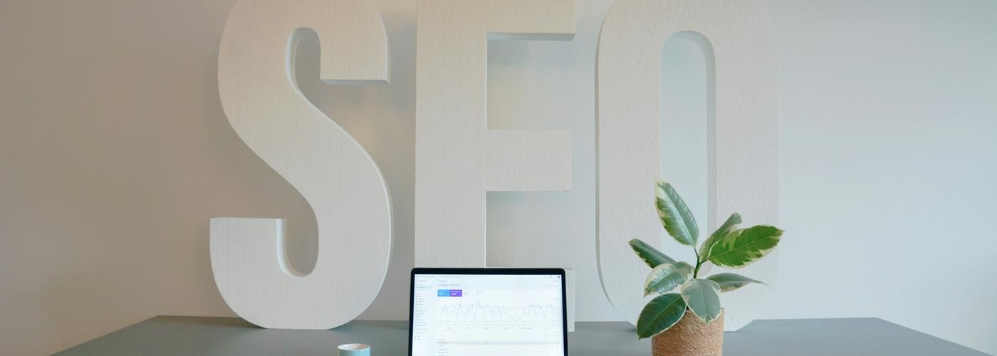 seo agency sign, marketing firm table with laptop and plant