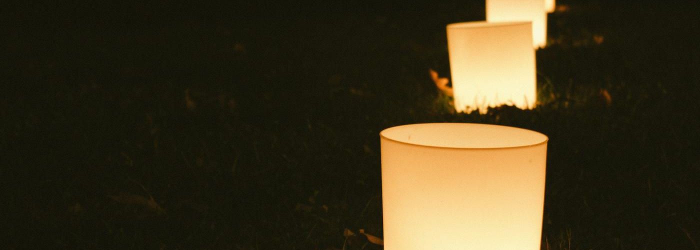 string of candles on the ground at night