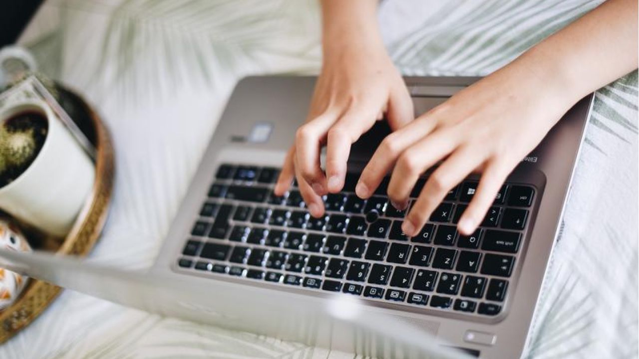 typing on a computer on a table