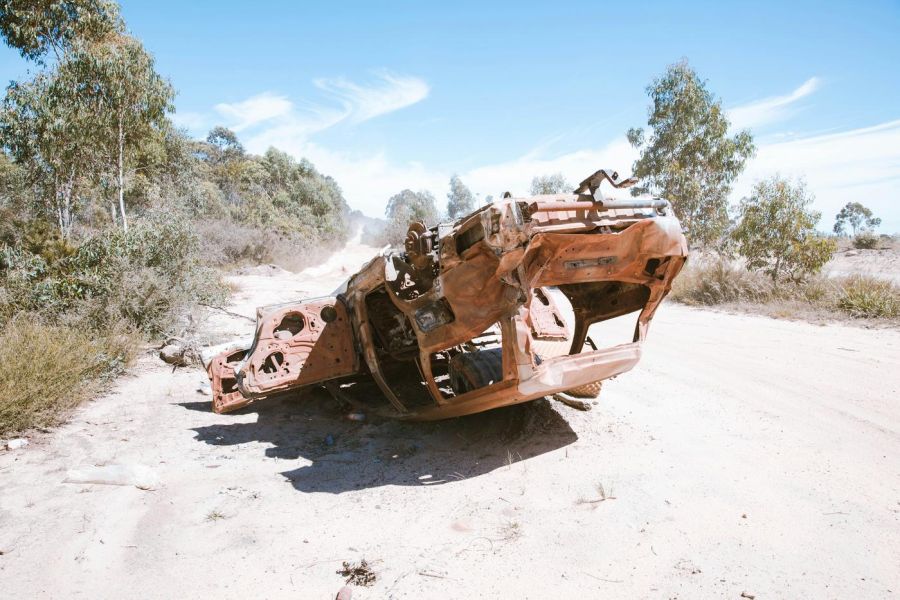 upside down car, destroyed on sand