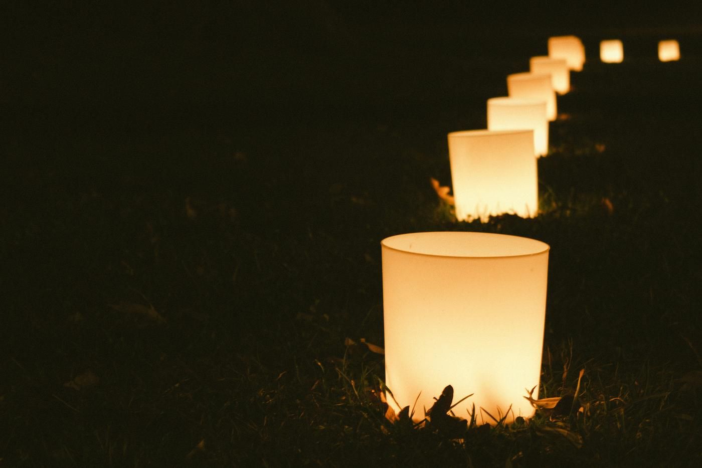 string of candles on the ground at night