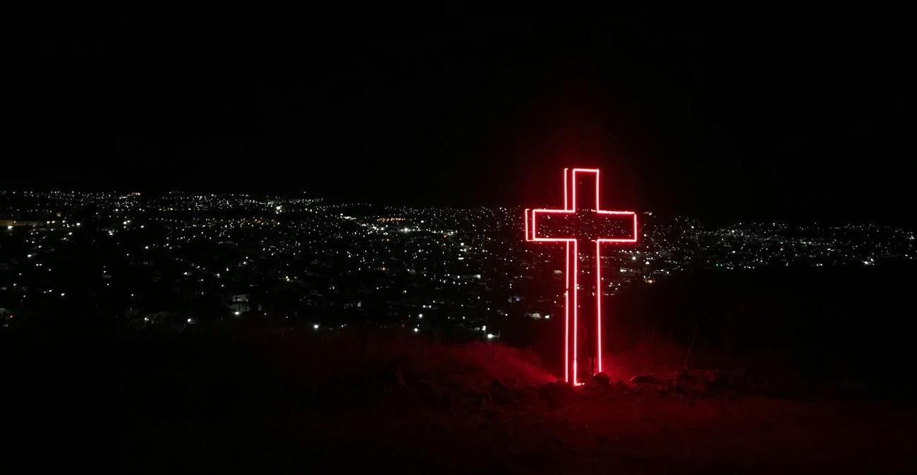 a cross in the city at night