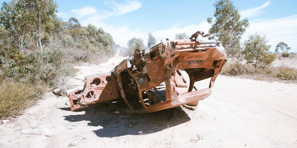 upside down car, destroyed on sand