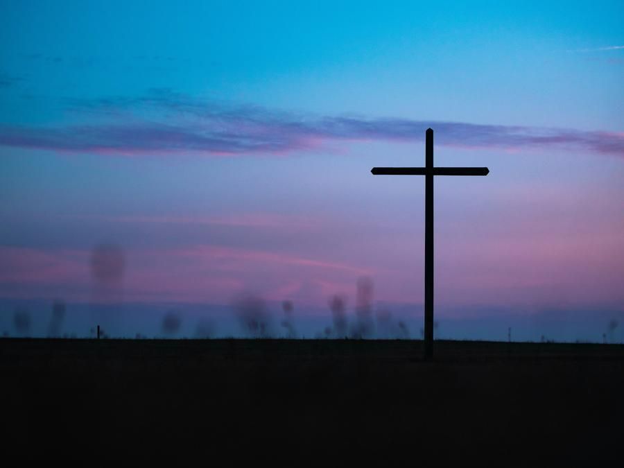  a cross in the sky in a field