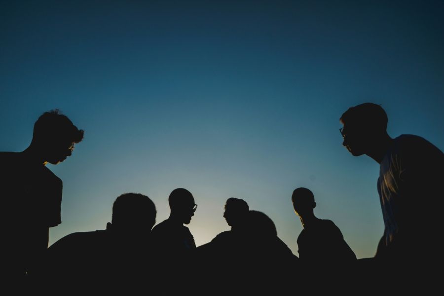 a group of men, outdoors at night