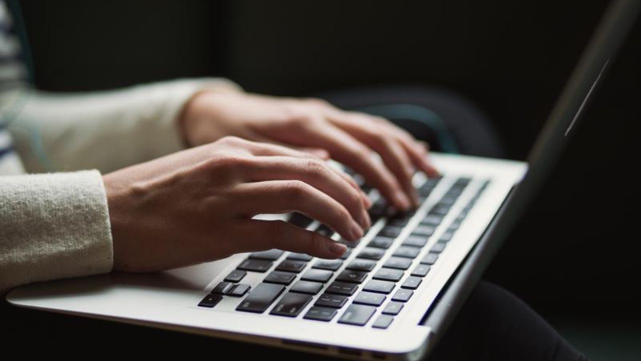 hands typing on a computer