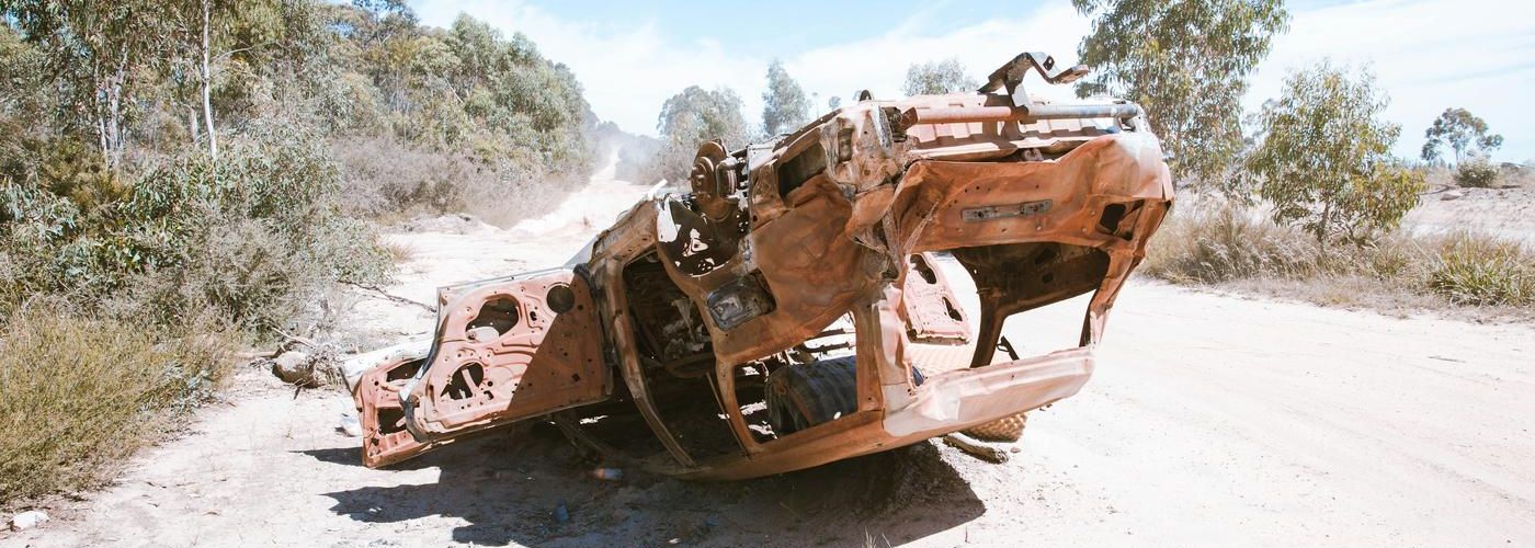 upside down car, destroyed on sand