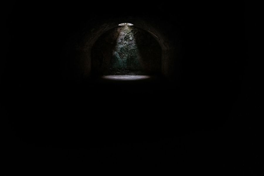 a dark dungeon with a light shining