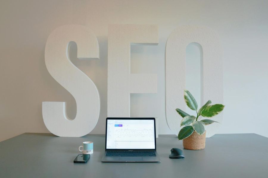 seo agency sign, marketing firm table with laptop and plant